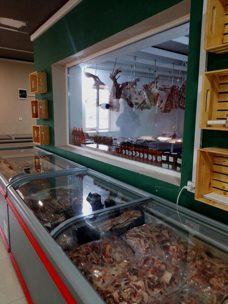 Agro Meat Market's skilled butcher at work.